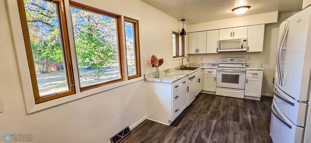 kitchen featuring white cabinetry, stainless steel appliances, dark hardwood / wood-style flooring, and sink