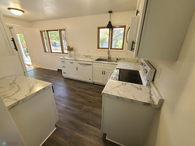 kitchen with sink, hanging light fixtures, a wealth of natural light, and white appliances