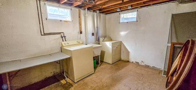 laundry room featuring a healthy amount of sunlight, sink, and washing machine and dryer