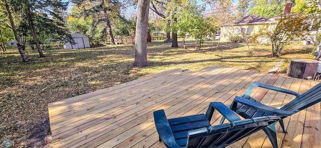 wooden deck featuring a storage unit and cooling unit