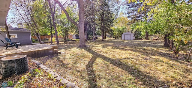 view of yard with a patio, a storage unit, and central AC unit