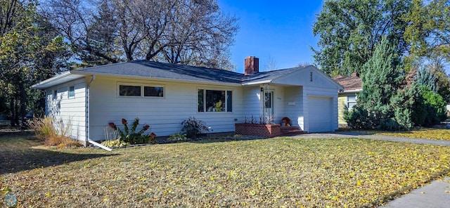 ranch-style house with a garage and a front lawn