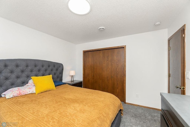 carpeted bedroom featuring a closet and a textured ceiling