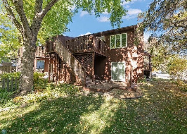 view of front of property featuring a front lawn and a wooden deck