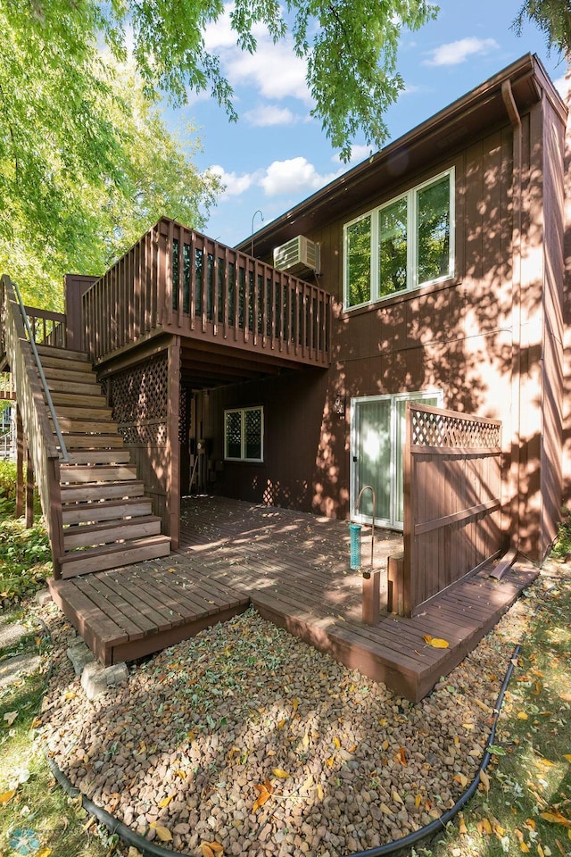 rear view of property featuring a wooden deck