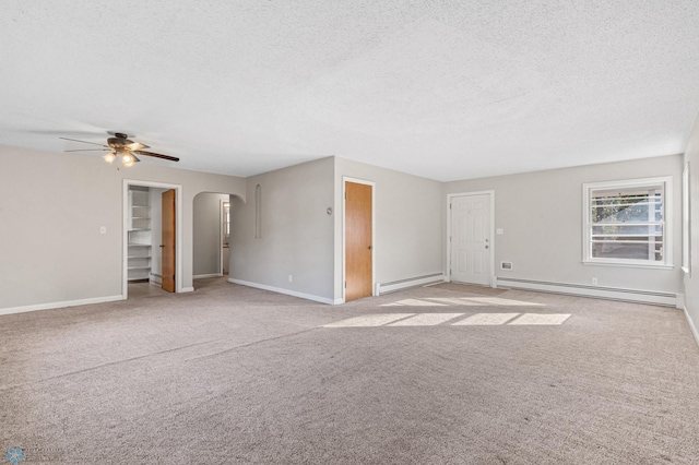 empty room with a baseboard heating unit, a textured ceiling, and ceiling fan