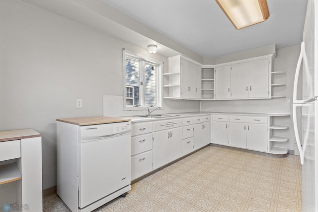 kitchen with white cabinets, sink, and white appliances