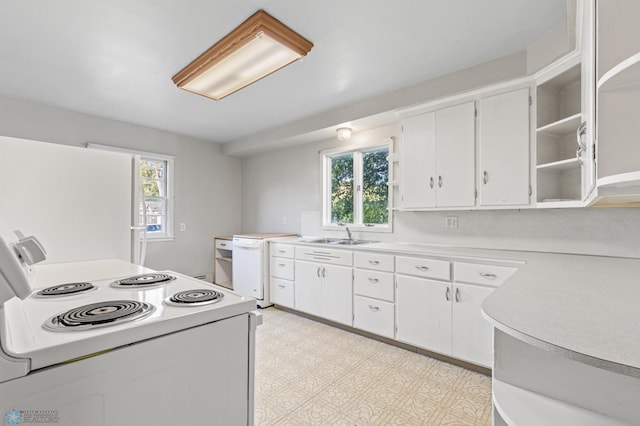 kitchen featuring white appliances, white cabinetry, and sink