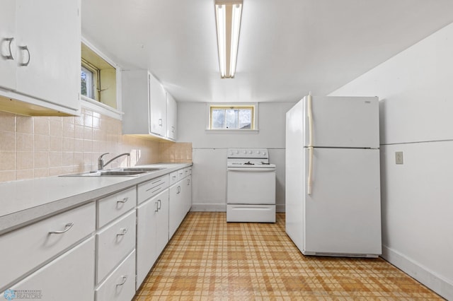 kitchen with white cabinets, sink, backsplash, and white appliances