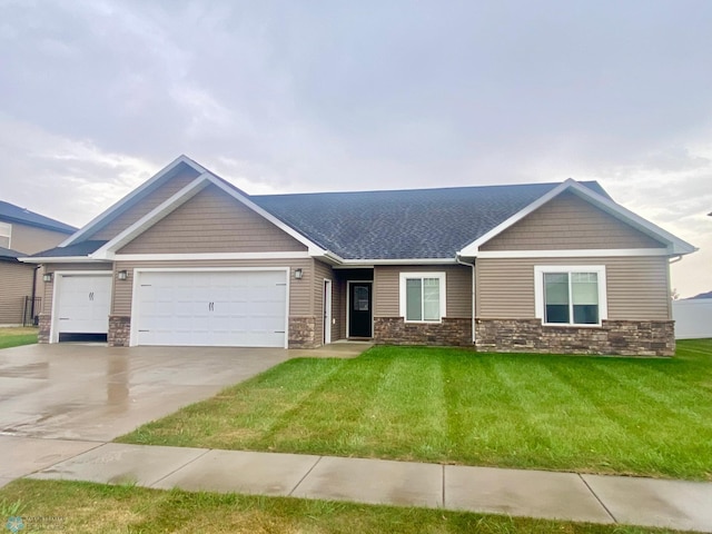 view of front facade with a garage and a front lawn