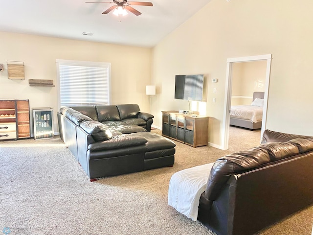 living room with light carpet, high vaulted ceiling, and ceiling fan