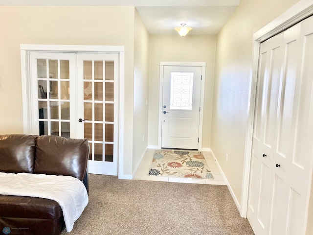 carpeted entryway featuring french doors