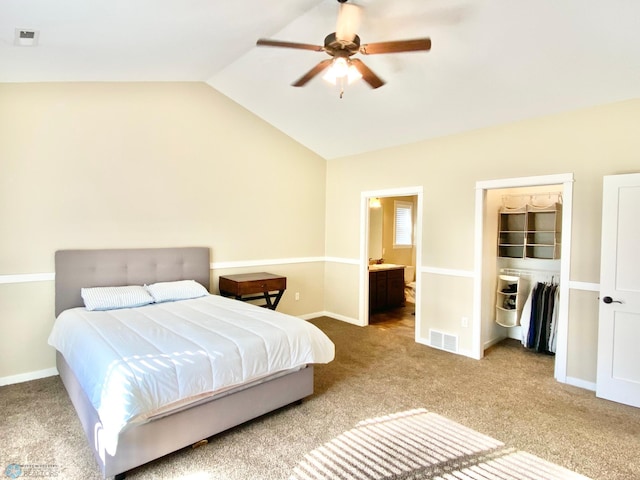 carpeted bedroom with vaulted ceiling, ensuite bathroom, a closet, and ceiling fan