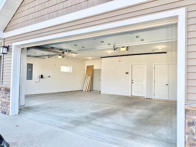 garage featuring electric panel and a garage door opener