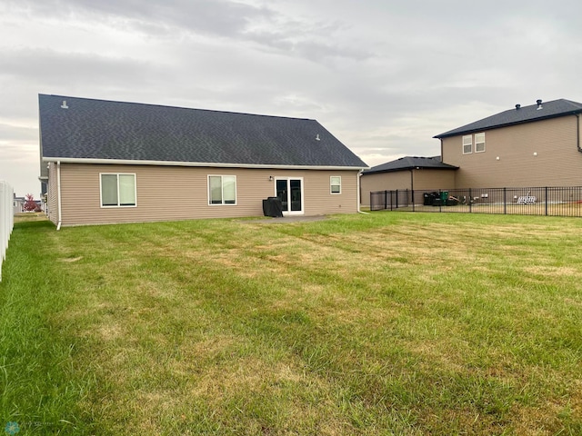 back of house featuring a yard