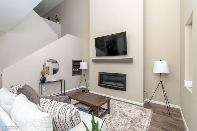 living room featuring dark hardwood / wood-style floors and a high ceiling