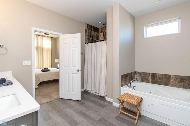 bathroom with wood-type flooring, independent shower and bath, and sink