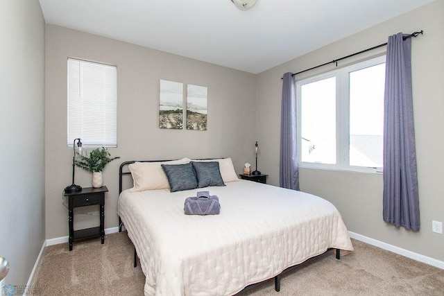 bedroom featuring light colored carpet