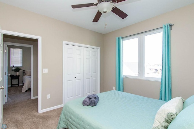 bedroom featuring a closet, light colored carpet, and ceiling fan