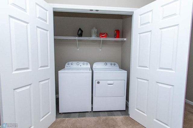 laundry area with washer and dryer and light colored carpet