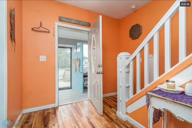 foyer with a textured ceiling and hardwood / wood-style flooring