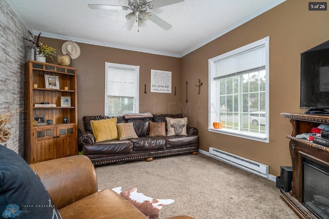 living room featuring carpet, a textured ceiling, a baseboard heating unit, and ornamental molding