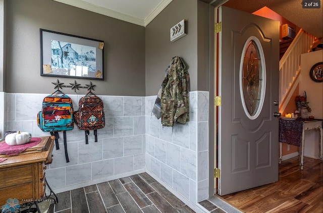 bathroom with crown molding, hardwood / wood-style floors, a textured ceiling, and tile walls