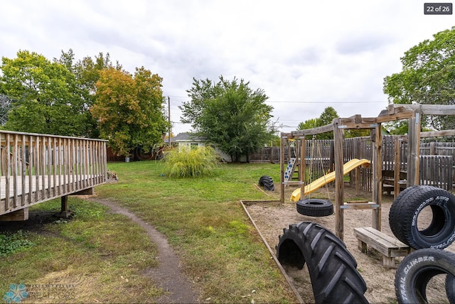 view of yard with a playground and a deck