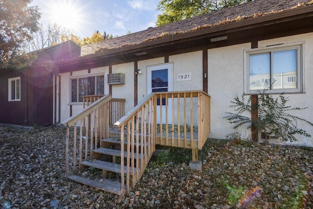 doorway to property featuring a wall mounted air conditioner