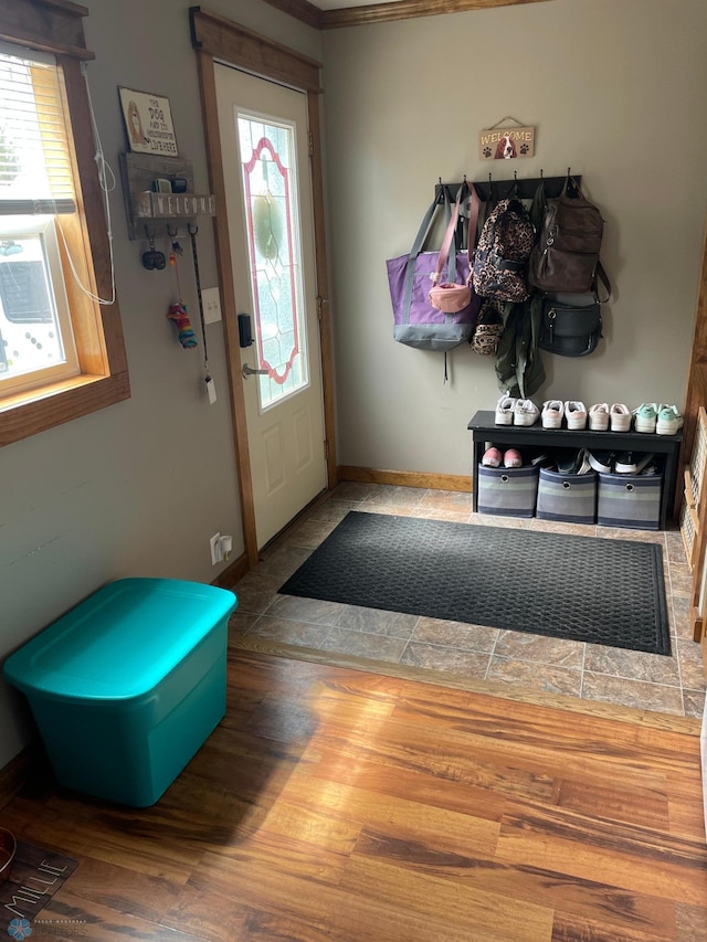 entrance foyer with ornamental molding and hardwood / wood-style flooring