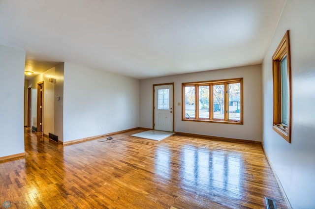 spare room featuring wood-type flooring