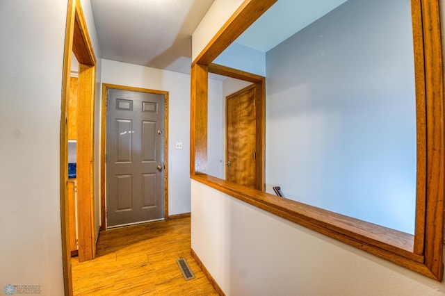 corridor with light wood-type flooring