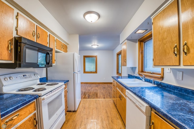 kitchen with light hardwood / wood-style floors, sink, and white appliances