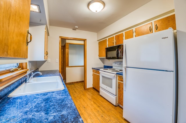 kitchen with light hardwood / wood-style flooring, sink, and white appliances