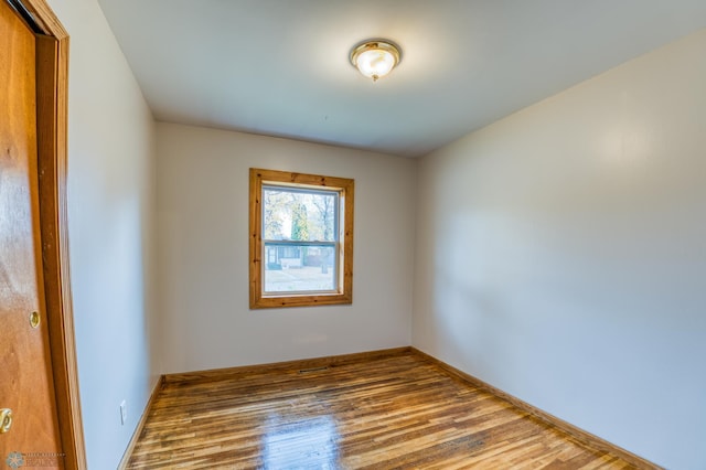 empty room with hardwood / wood-style flooring