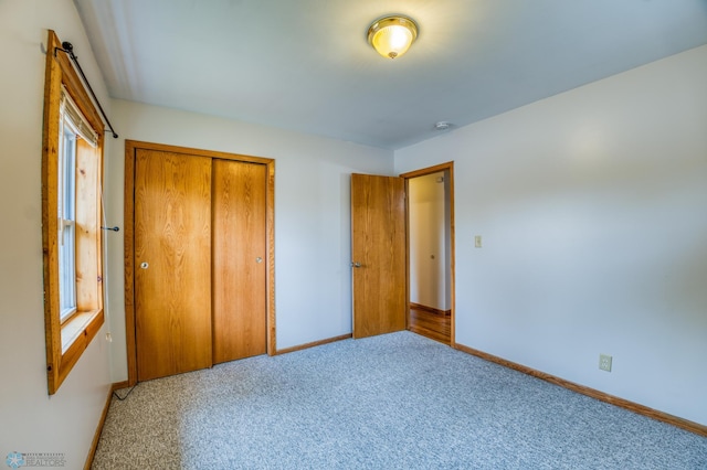 unfurnished bedroom with carpet floors and a closet