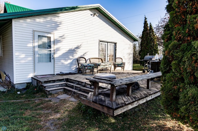 back of property with a wooden deck