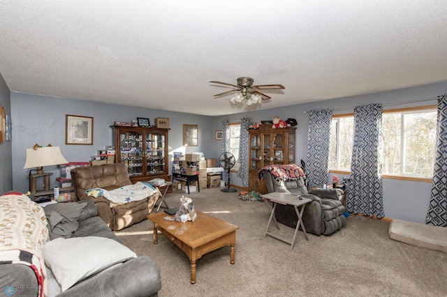 living room featuring carpet, a textured ceiling, and ceiling fan