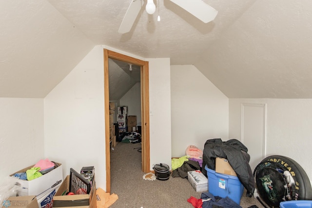 bonus room featuring lofted ceiling, carpet, a textured ceiling, and ceiling fan