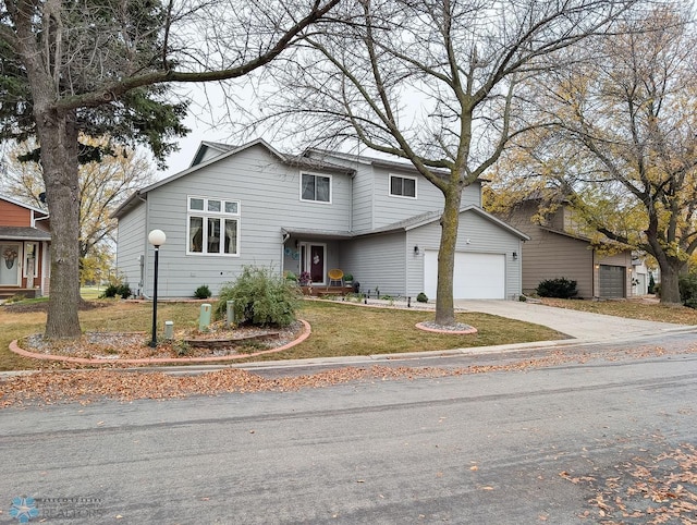 view of front property featuring a front lawn and a garage