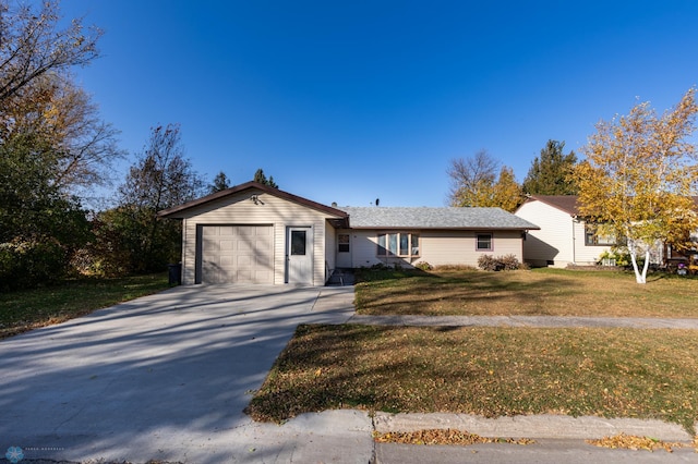 view of front facade featuring a garage and a front lawn