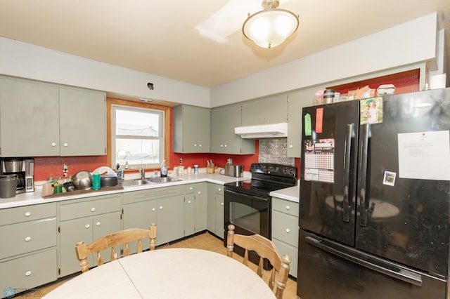 kitchen featuring decorative backsplash, green cabinets, black appliances, and sink