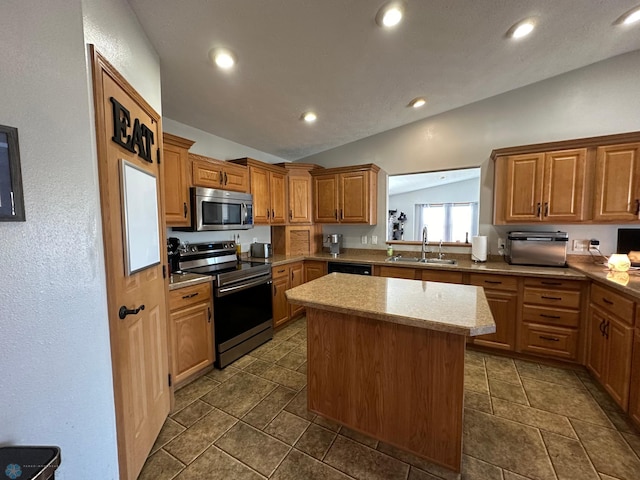 kitchen with lofted ceiling, light stone counters, a kitchen island, sink, and stainless steel appliances