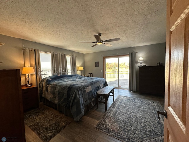 bedroom featuring dark hardwood / wood-style floors, access to exterior, a textured ceiling, and ceiling fan