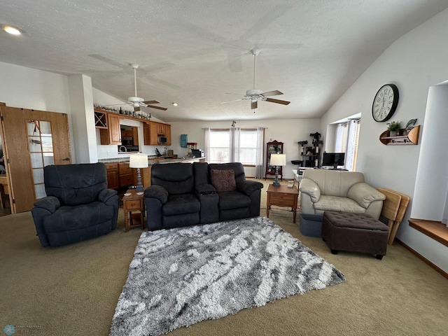 carpeted living room with a textured ceiling, ceiling fan, and vaulted ceiling