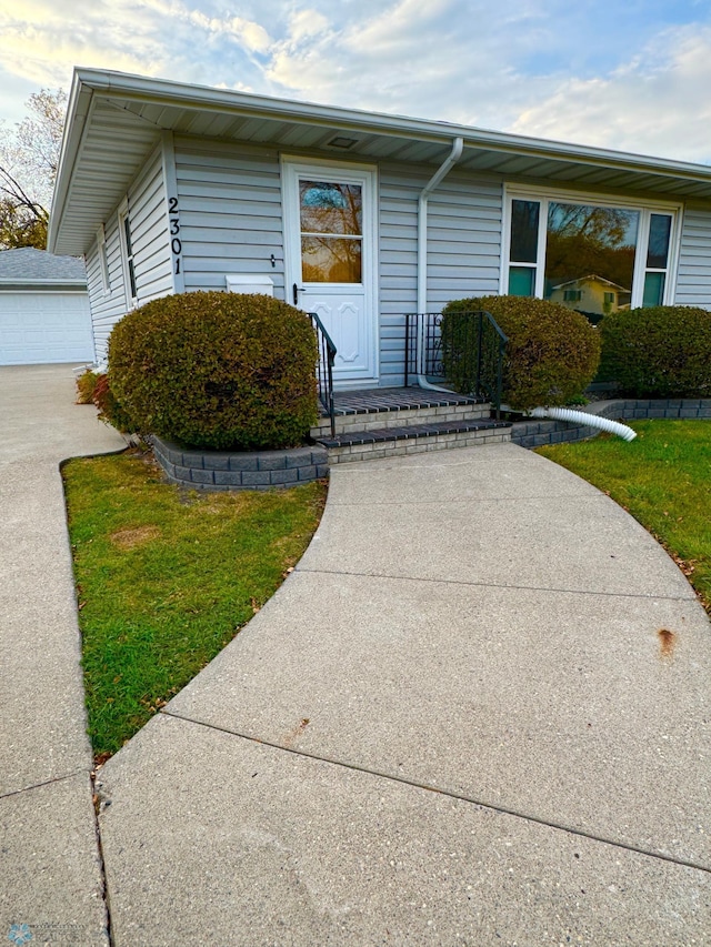 doorway to property with a lawn