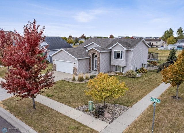 view of front of property featuring a front yard and a garage