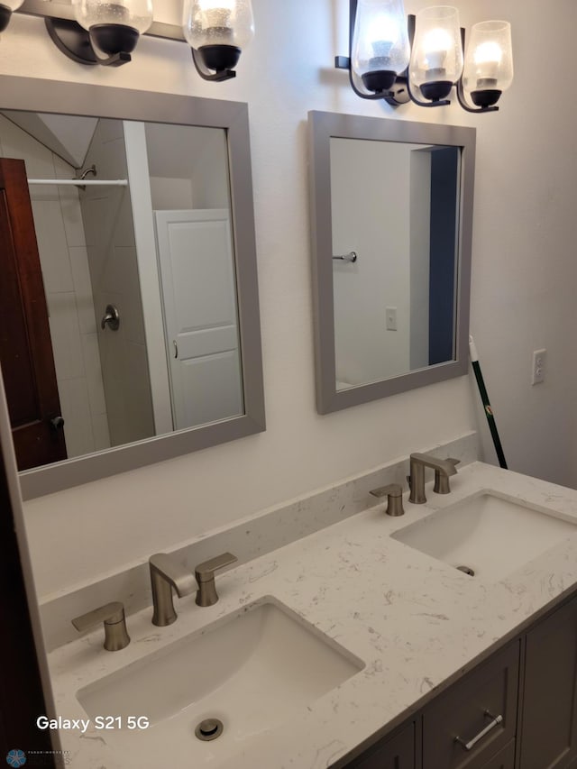 bathroom with vanity and tiled shower