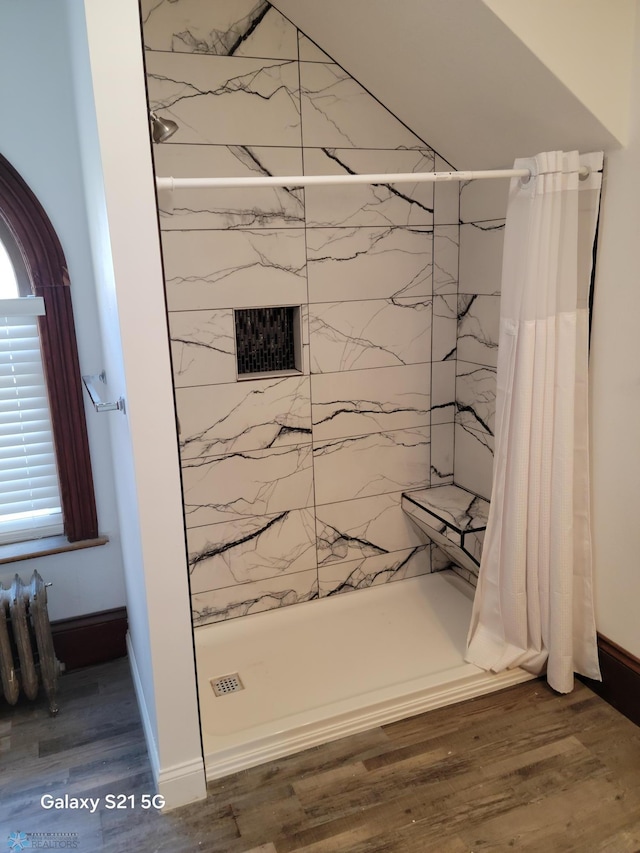 bathroom featuring curtained shower and hardwood / wood-style flooring