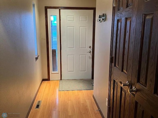 doorway with light hardwood / wood-style flooring